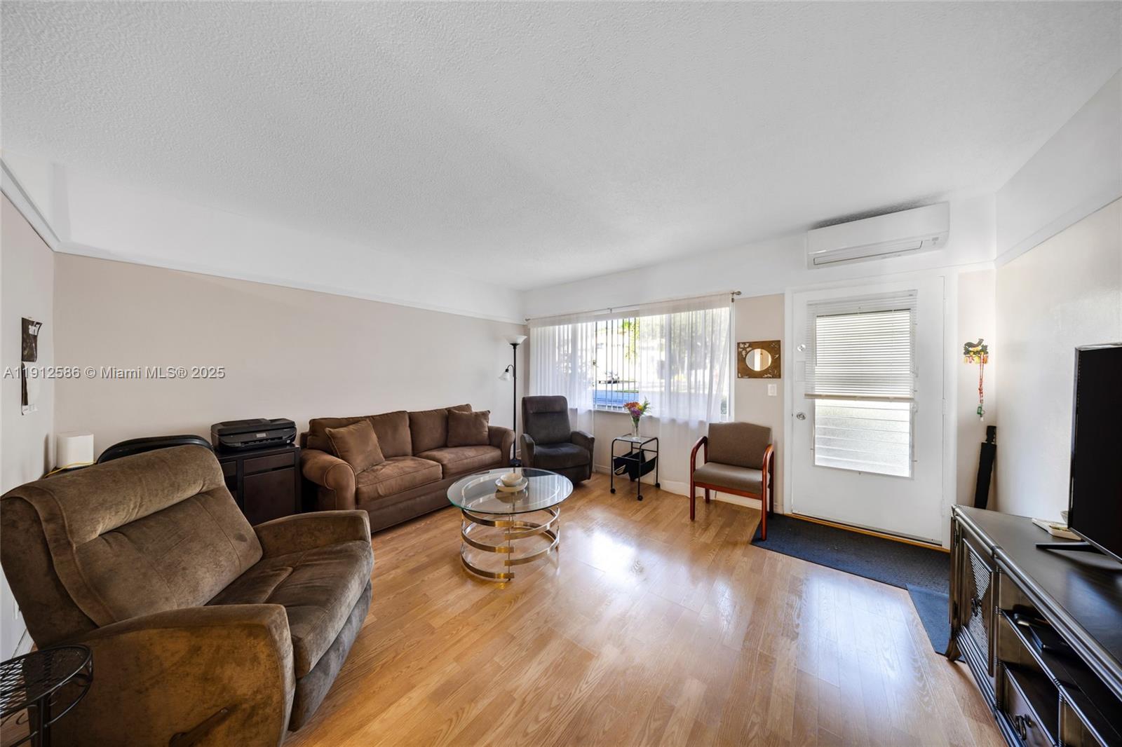 900 Southwest 10th Terrace, Unit 8S Hallandale Beach, FL 33009 - Photo 3 of 33 a living room with furniture and a flat screen tv