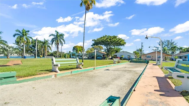 a view of swimming pool with palm trees