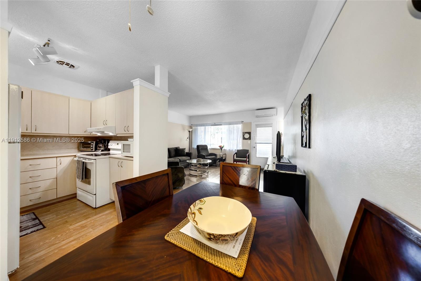 900 Southwest 10th Terrace, Unit 8S Hallandale Beach, FL 33009 - Photo 7 of 33 a living room with granite countertop kitchen island furniture a sink a kitchen island and stainless steel appliances