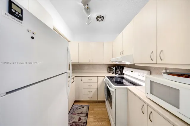 a kitchen with a sink a stove and cabinets