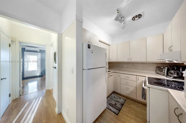 a kitchen with a sink stainless steel appliances and cabinets