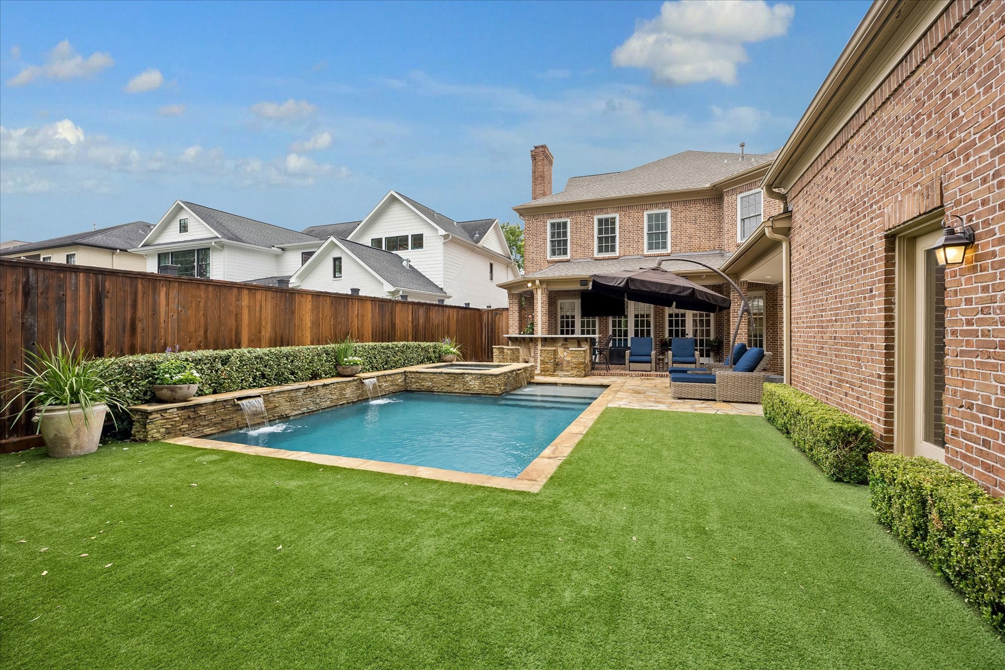 6358 Auden Street Houston, TX 77005 - Photo 42 of 50 a view of a patio with couches and a table and chairs with plants and wooden fence