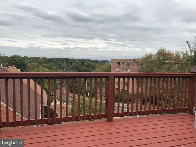 a view of balcony with wooden floor and fence