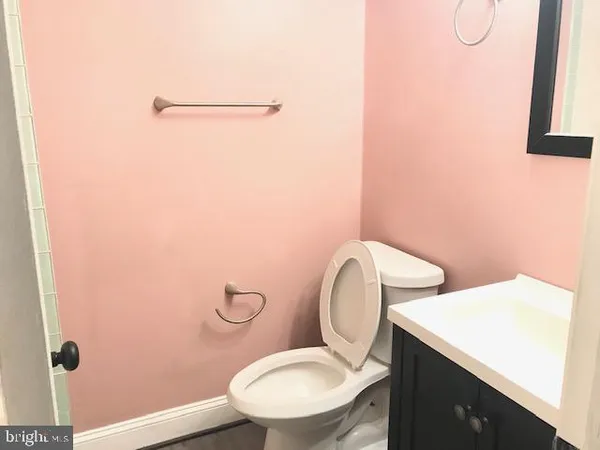 a white toilet sitting next to a bathroom sink