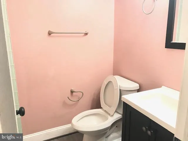 a white toilet sitting next to a bathroom sink