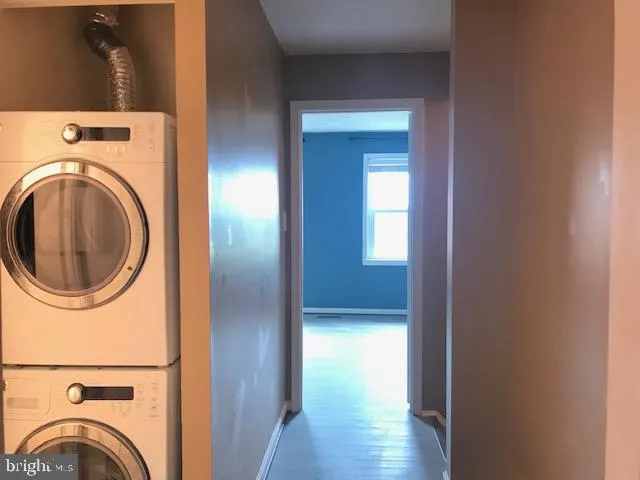 a view of a hallway with washer and dryer