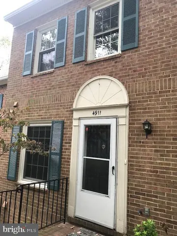 a view of a brick house with large windows