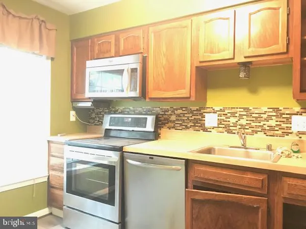 a view of a kitchen with a sink and a window