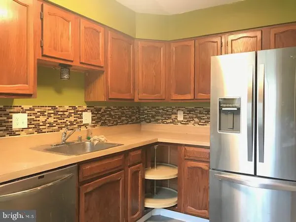 a kitchen with a refrigerator and a sink