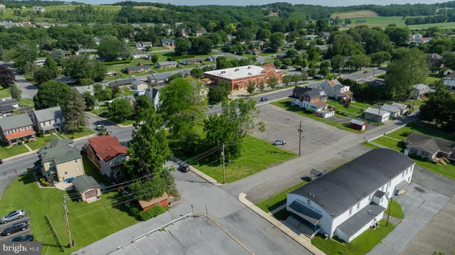 an aerial view of a house with a garden and lake view