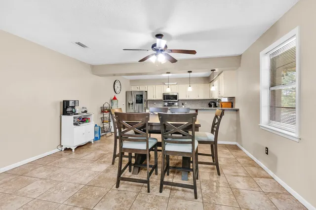a view of a dining room with furniture and window