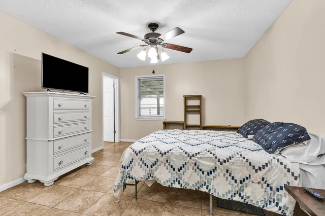 a bedroom with a large bed and a flat screen tv