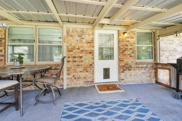 a living room with furniture and next to a window