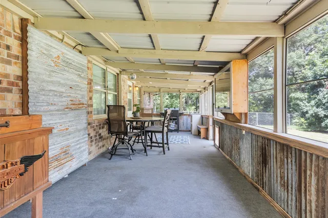 a view of a porch with furniture and a gate
