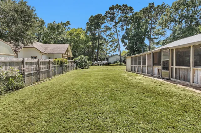 a view of a backyard with a garden and tree