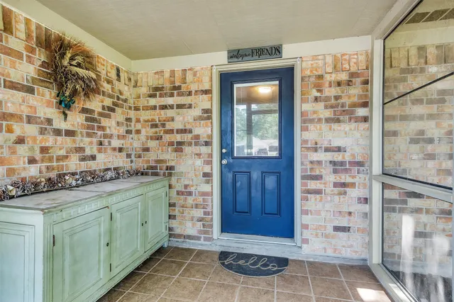 a bathroom with a granite countertop sink a mirror and shower