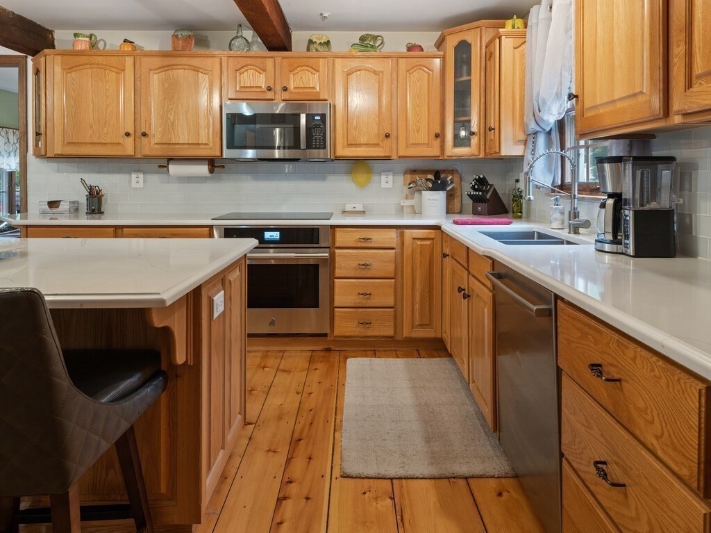58 Fitzpatrick Road Grafton, MA 01519 - Photo 9 of 41 a kitchen with stainless steel appliances granite countertop a stove a sink and a microwave