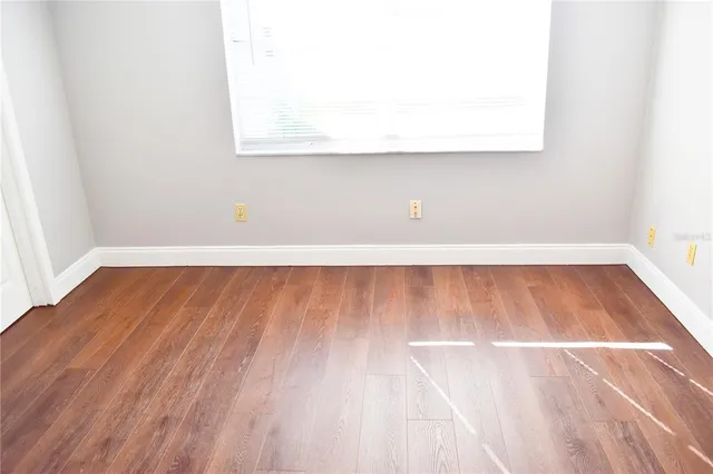a view of a room with wooden floor