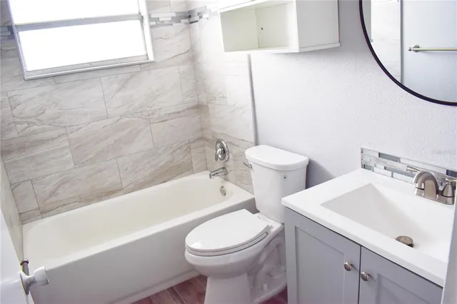a bathroom with a sink a toilet and a bathtub