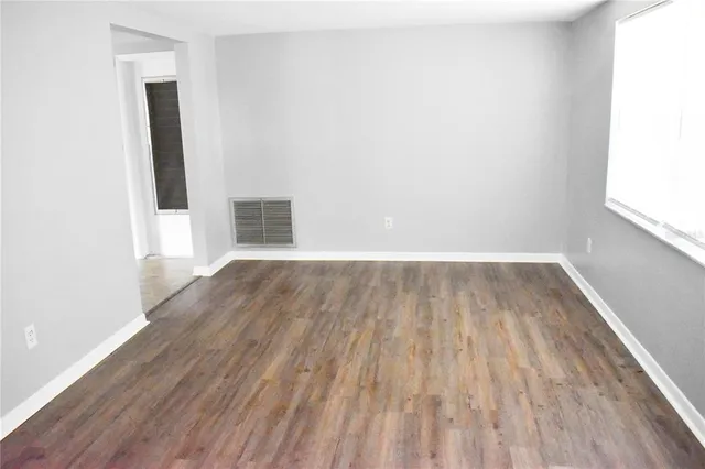 a view of a room with wooden floor