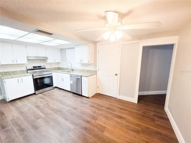 a kitchen with a stove a sink and a refrigerator