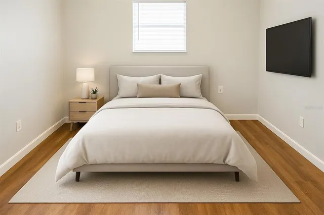 a bedroom with a bed and a flat screen tv