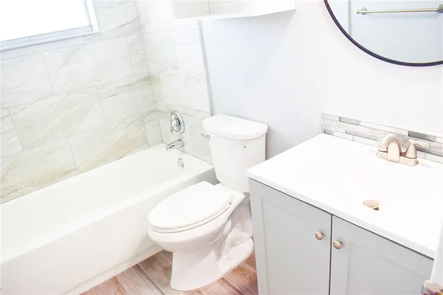 a white toilet sitting next to a bathroom sink