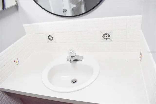 a bathroom with a sink and mirror