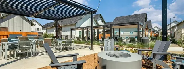 a view of a patio with chairs and potted plants