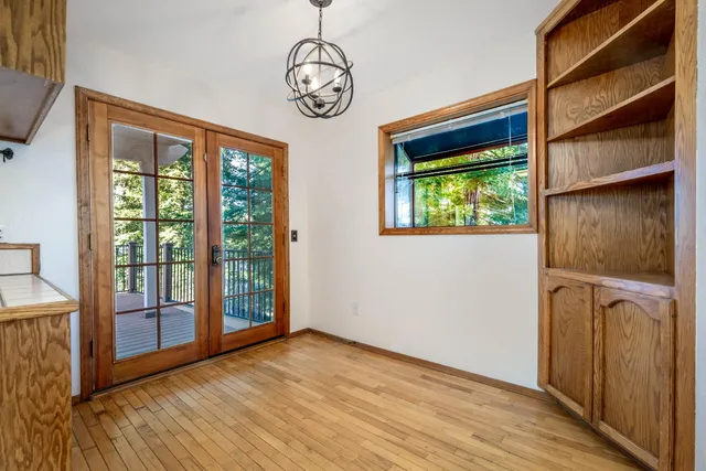 a view of backyard with large windows and a small yard