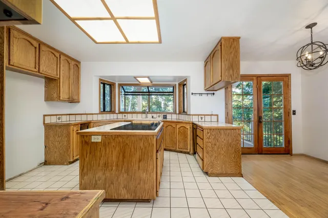 a view of a house with a small yard and wooden fence