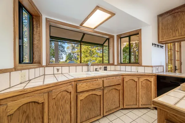 a view of a house with wooden floor and a barbeque grill