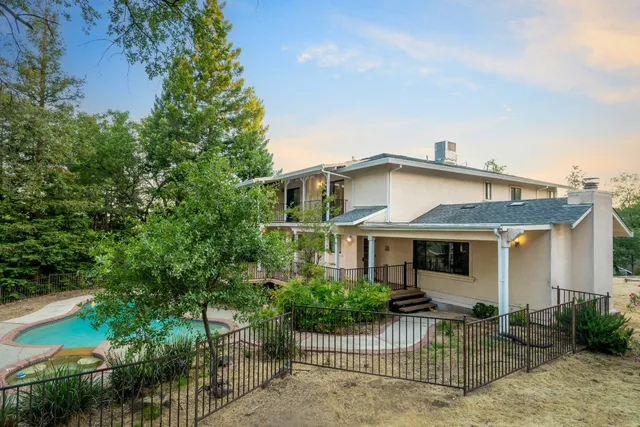 a view of an empty room with closet and a window