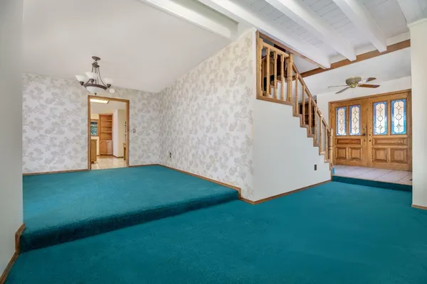 an empty room with a projector and painted walls