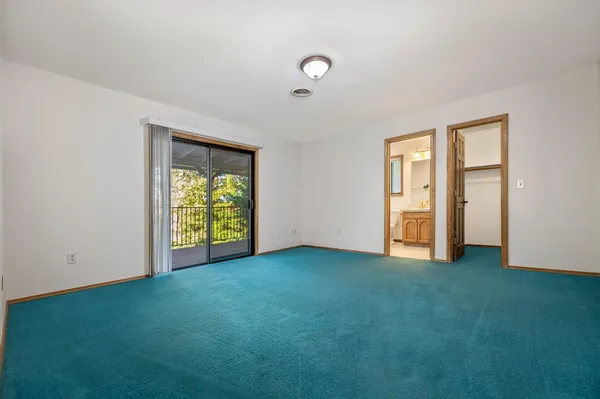 a view of a chairs and table in the balcony
