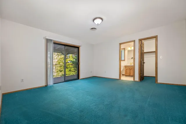 a view of a chairs and table in the balcony