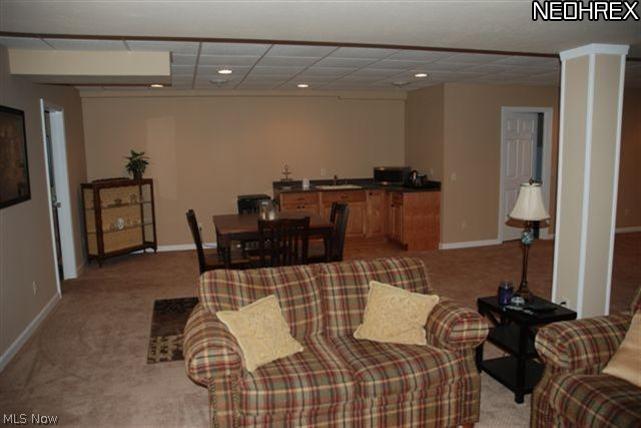 7036 Sweetwater Road Northeast Canton, OH 44721 - Photo 12 of 14 Partial view of the lower level. There is also a large area for a pool table or whatever else your buyers lifestyle desires. To the rear is a wetbar/kitchenette area. Also a great feature-lots of clean dry storage. A work out room is in place by this owner, in some of that area.