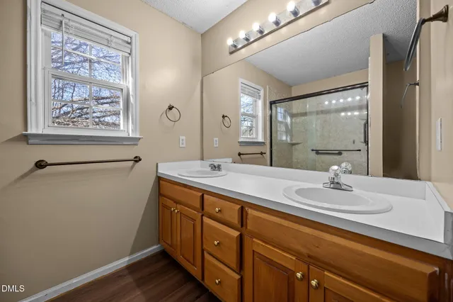 a bathroom with a double vanity sink and a mirror