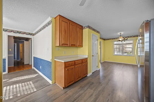 a kitchen with stainless steel appliances granite countertop a refrigerator and a stove top oven