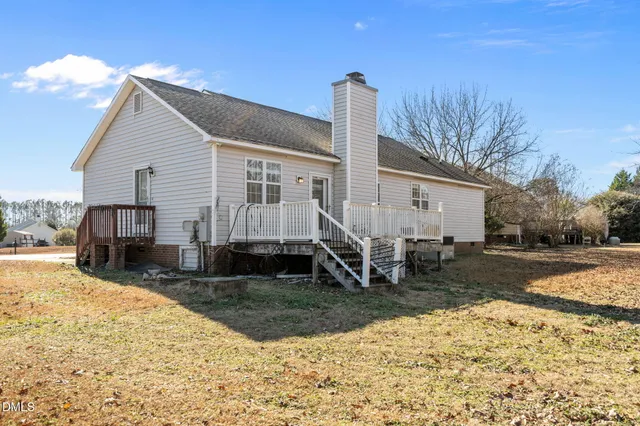 a view of a house with a yard covered in snow