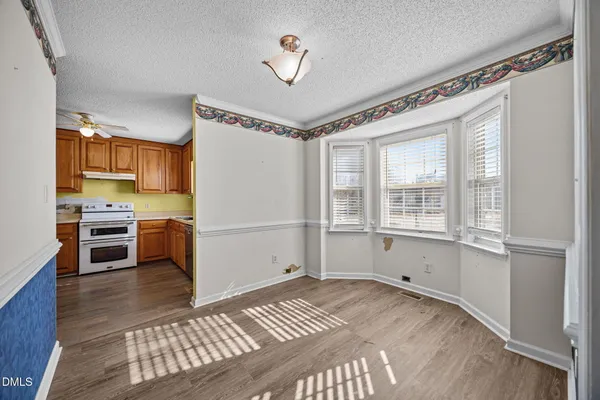 a bedroom with a bed cabinets and a window