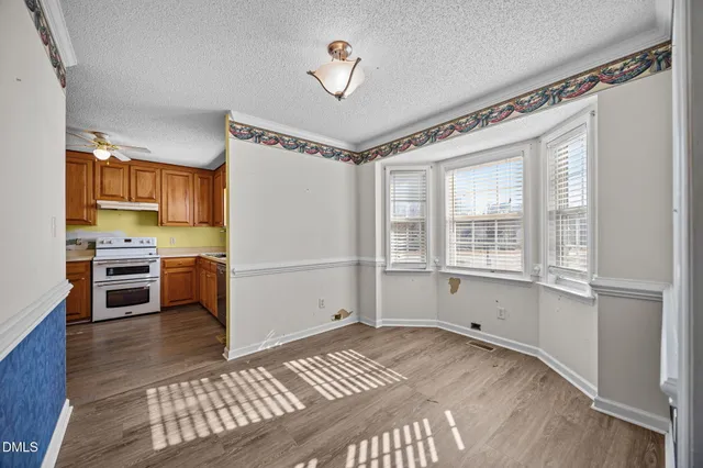a bedroom with a bed cabinets and a window