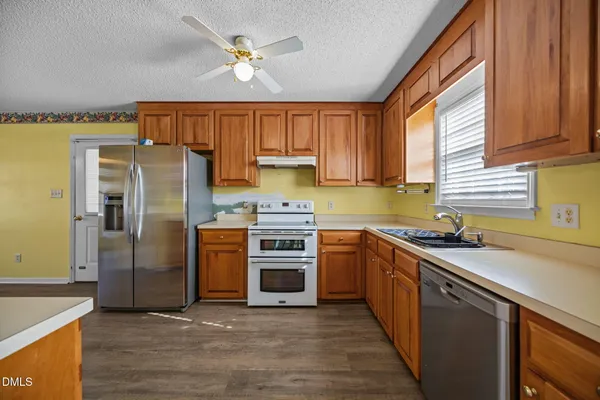 a kitchen with a sink stove and refrigerator
