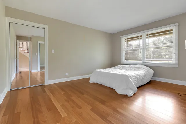a bathroom with a sink a toilet and a large mirror