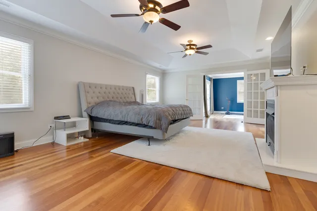 a bedroom with a bed lamps and a fireplace