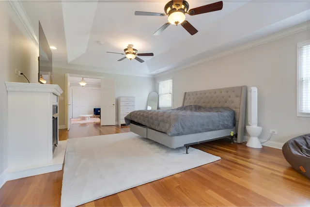 a bedroom with a bed and a desk next to a window