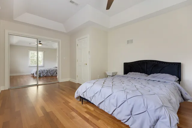 a bedroom with a bed dresser and a flat screen tv