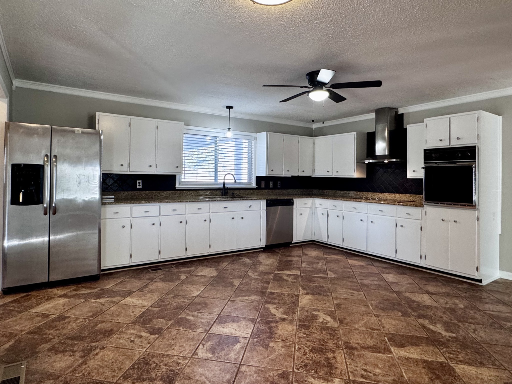 211 Church Street Loretto, TN 38469 - Photo 11 of 37 a large kitchen with cabinets
