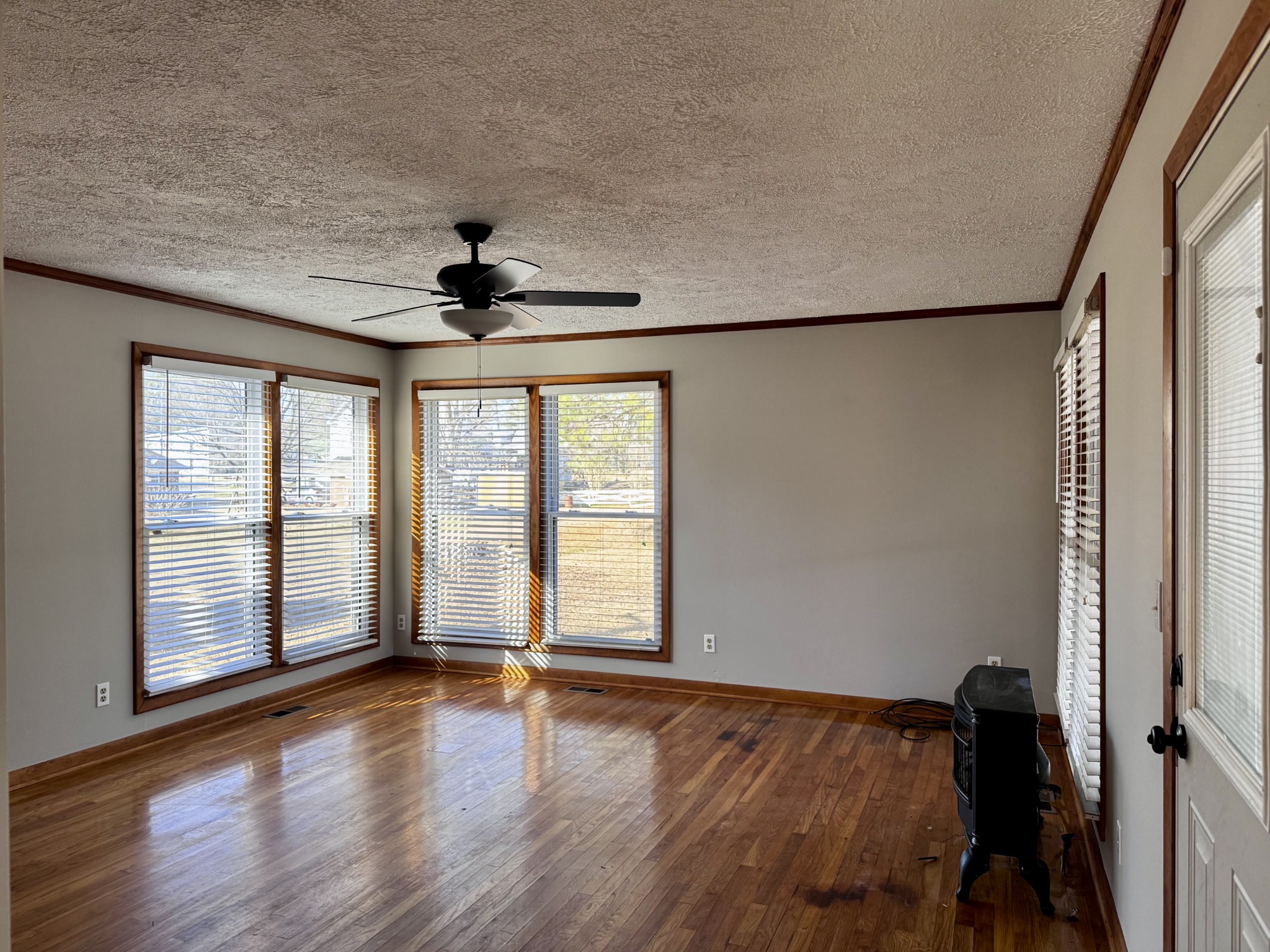 211 Church Street Loretto, TN 38469 - Photo 16 of 37 a view of an empty room with a window and wooden floor