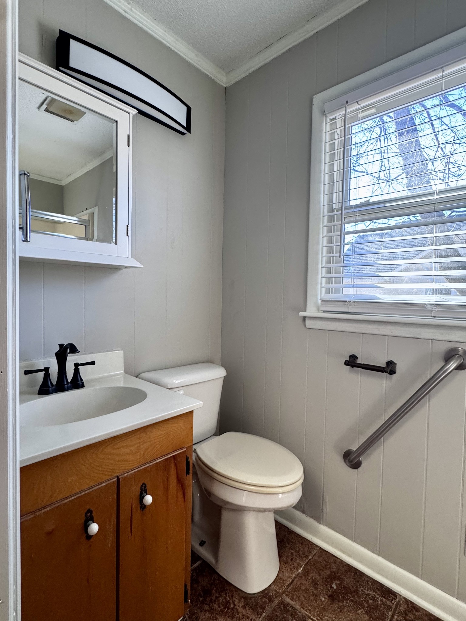 211 Church Street Loretto, TN 38469 - Photo 17 of 37 a bathroom with a granite countertop sink toilet and mirror